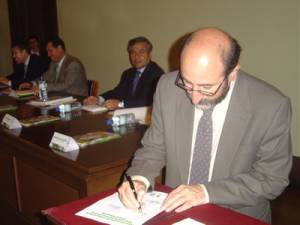 Minister Lozano signing the agreement